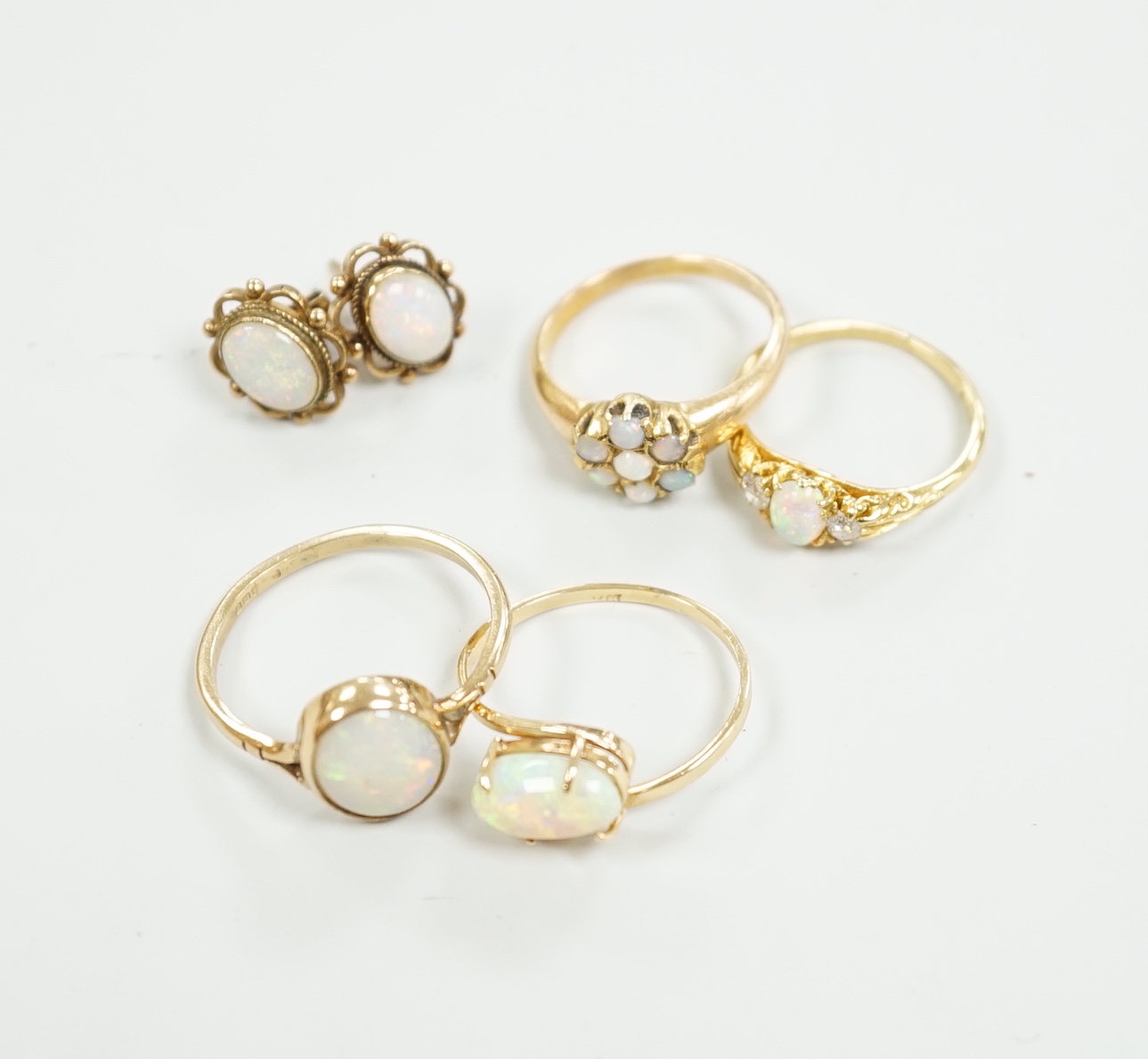 Two 18ct and white opal set rings, one with diamonds, gross 6.2 grams, a 14ct and white opal ring, a 9ct gold and white opal ring and a pair of 9ct gold and white opal earrings.